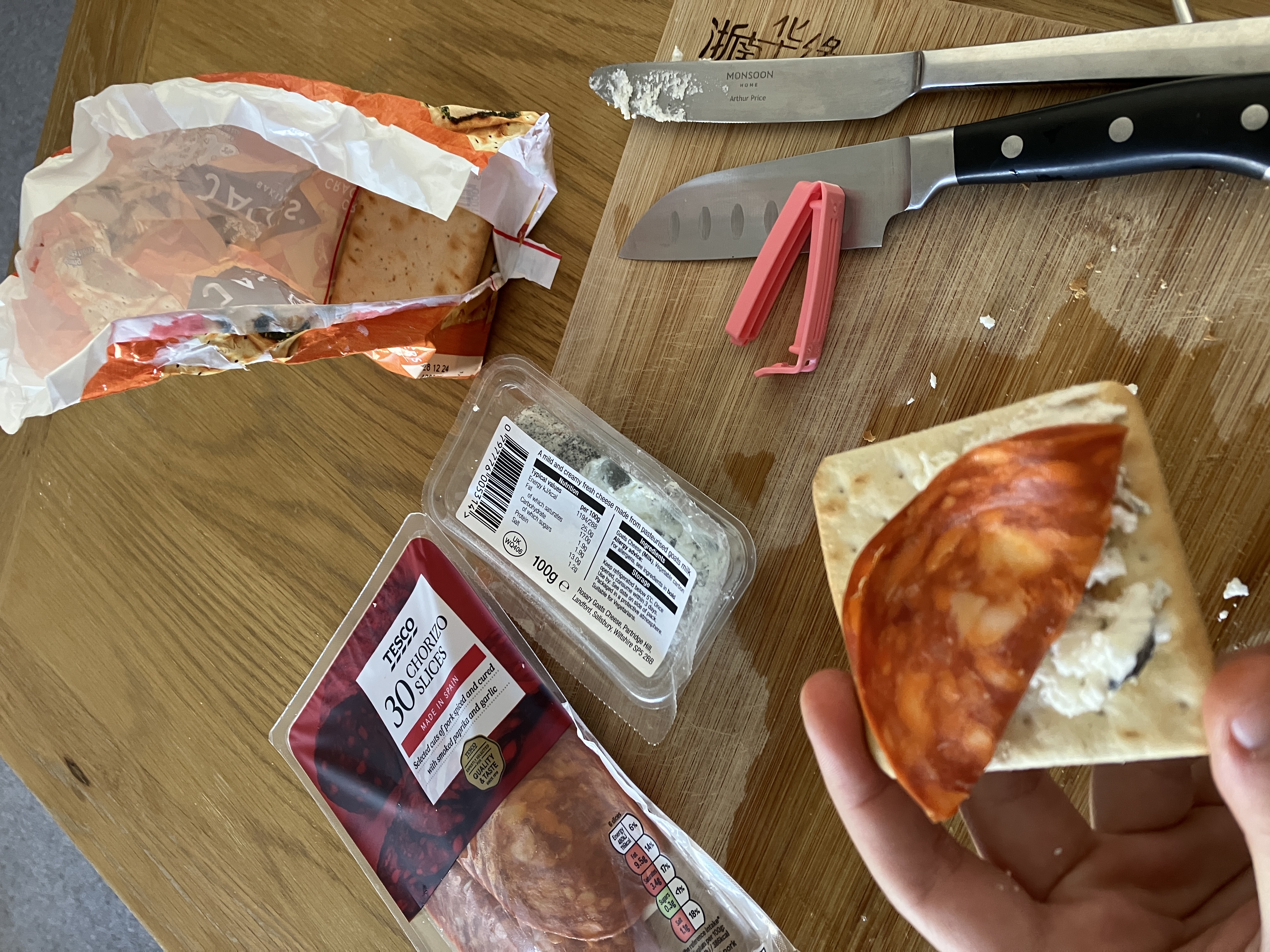 the same food but there is now a pack of thinly sliced chorizo and two knives on the board the same food but there is now a pack of thinly sliced chorizo and two knives on the board